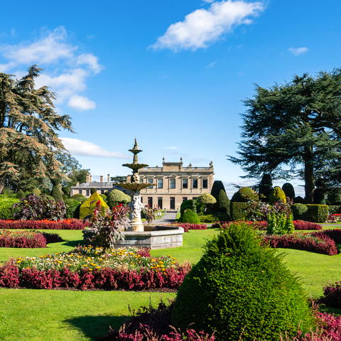The gardens with view of Brodsworth Hall on a sunny day.